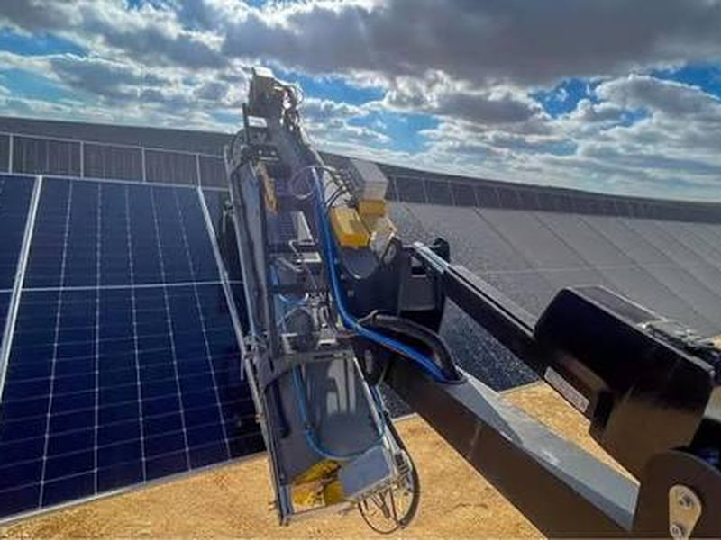 Solar panel cleaning crew washing a dusty solar array